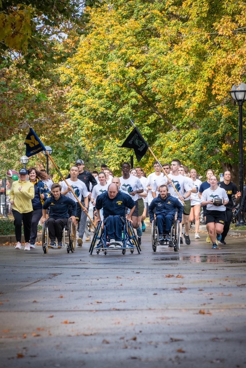 Last mile of race with runners and student athletes in wheelchairs